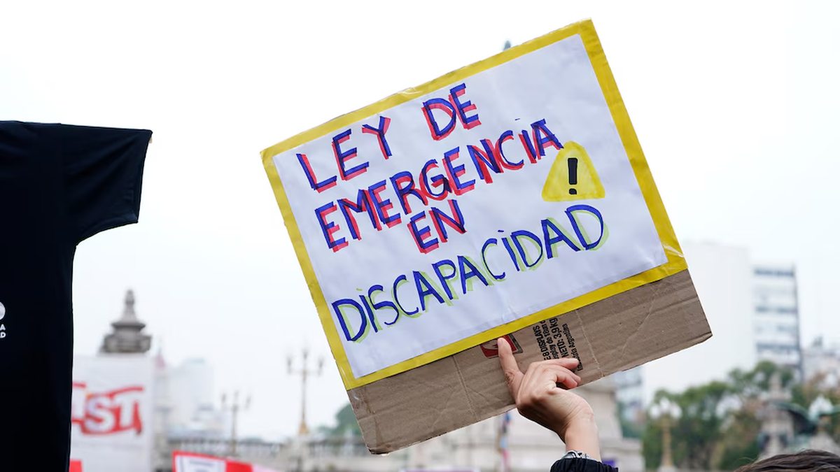 Personas y carteles en una movilización por discapacidad; imagen de archivo.