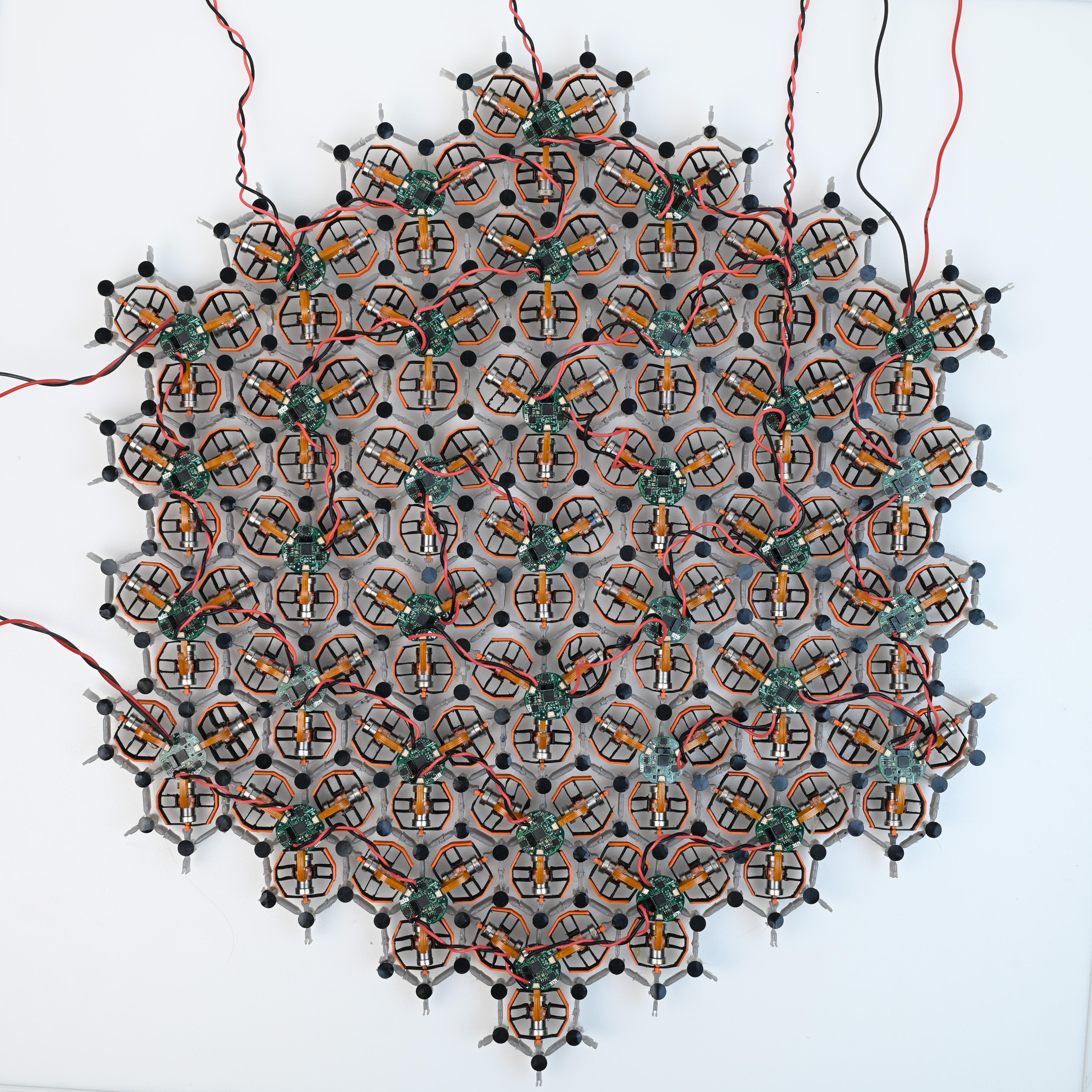 Fotografía de archivo del dispositivo experimental de 37 unidades, con piezas hexagonales, cables y placas electrónicas sobre una superficie clara. Tomada el 27 de junio de 2025.